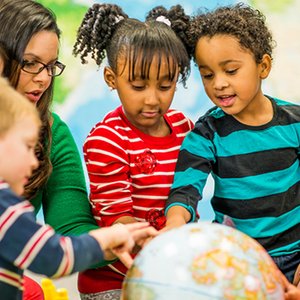 Children and teacher engaged in a collaborative classroom activity.