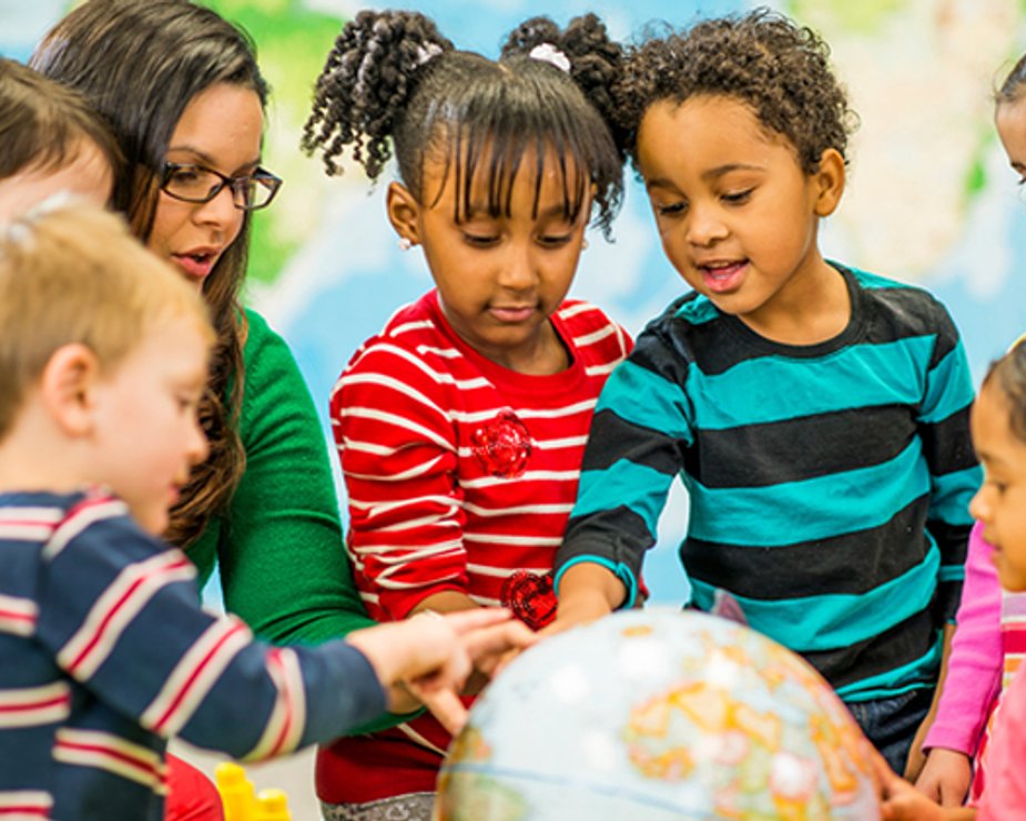 Children learning with teacher support during extended daycare hours.