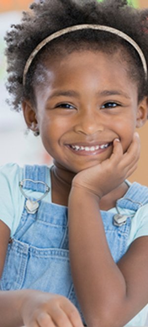 Child smiling during a positive classroom moment.