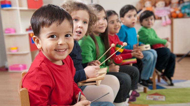 Children participating in a music activity together.