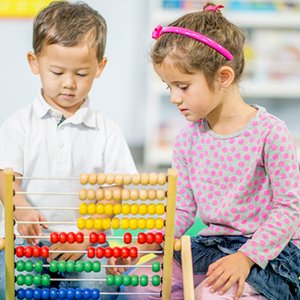 Children exploring counting beads during guided learning.
