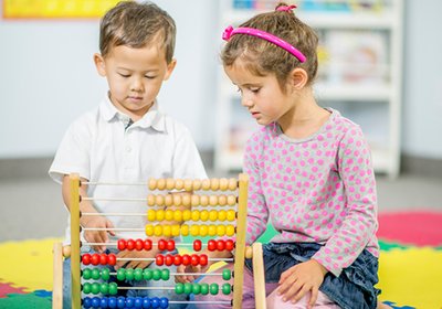 Toddlers exploring counting beads during guided learning