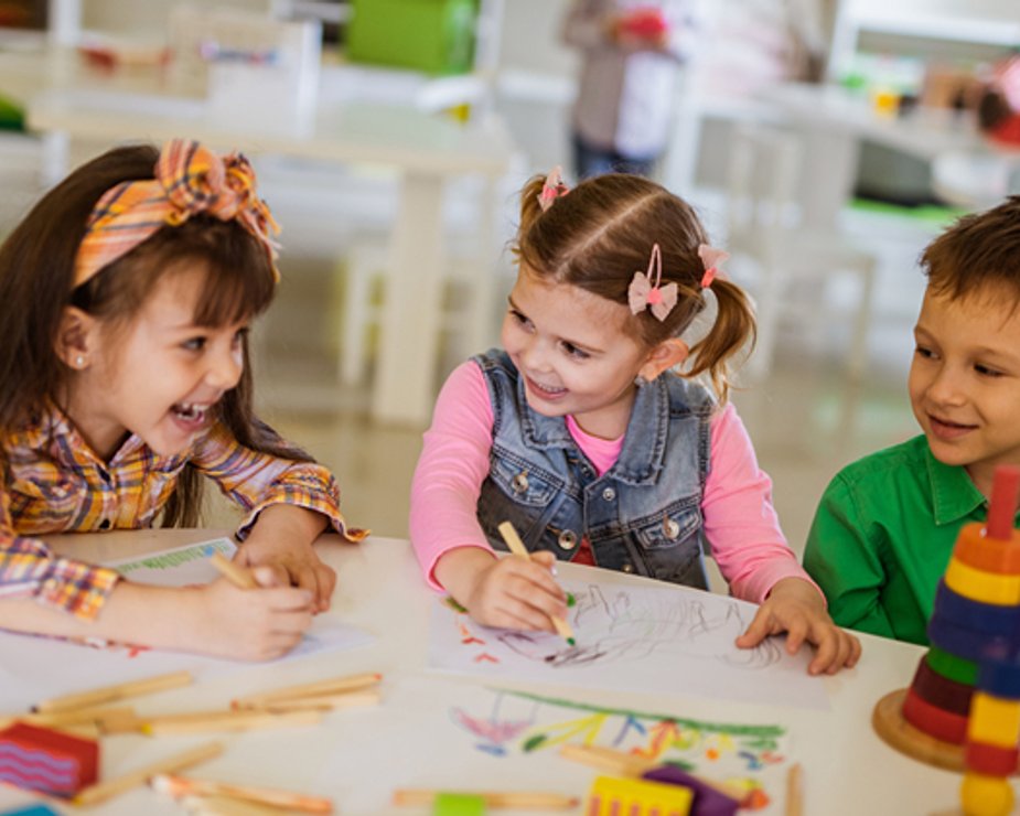 Children working together on classroom drawing activities.