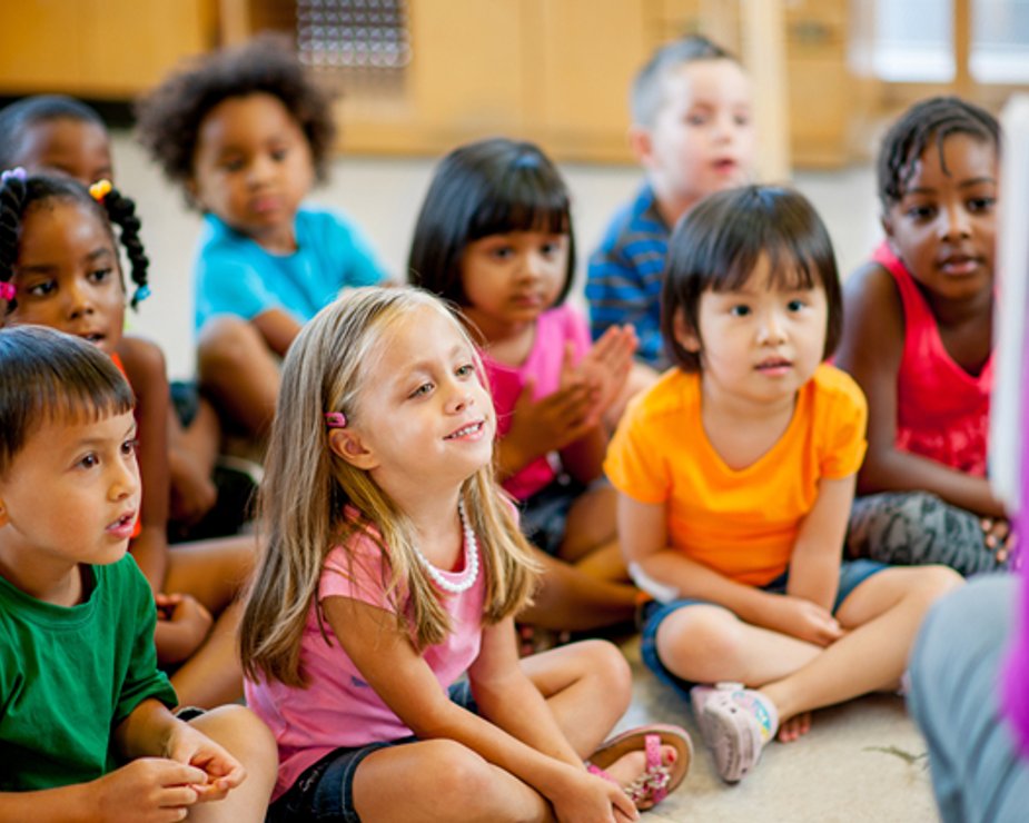 Diverse group of children engaged during circle time.
