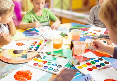 Preschool children painting and creating art together