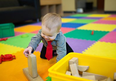 Infant exploring blocks during supervised play