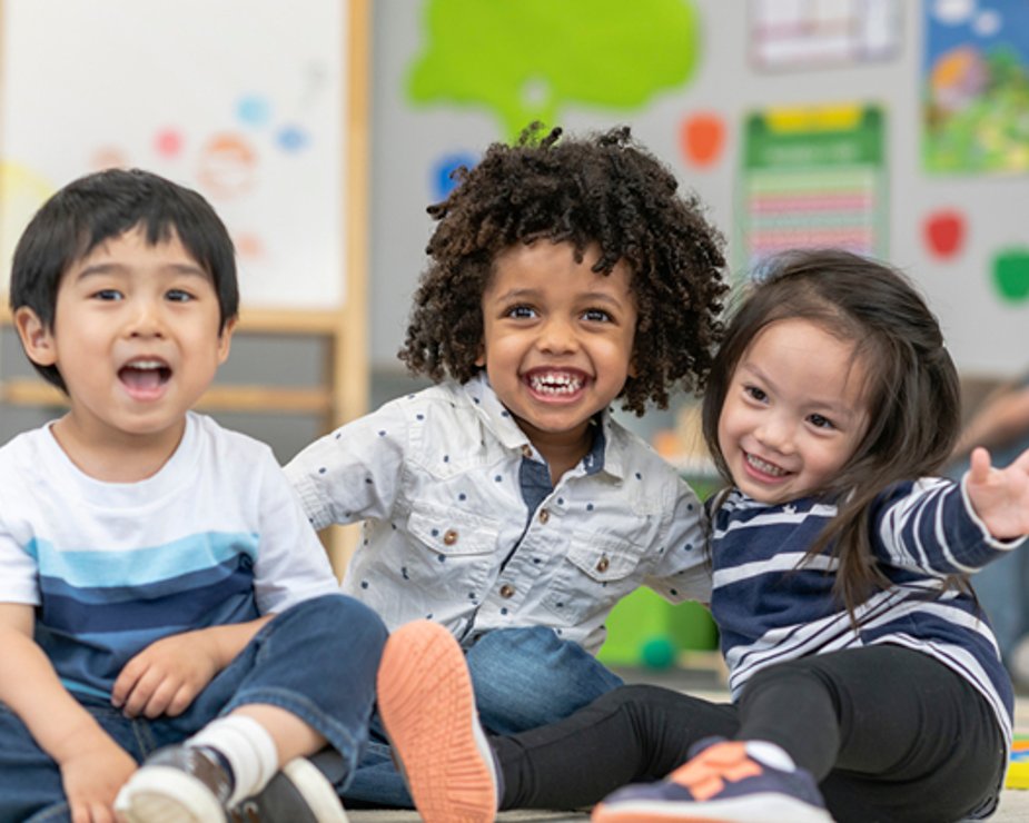 Children listening during teacher-led classroom activity.