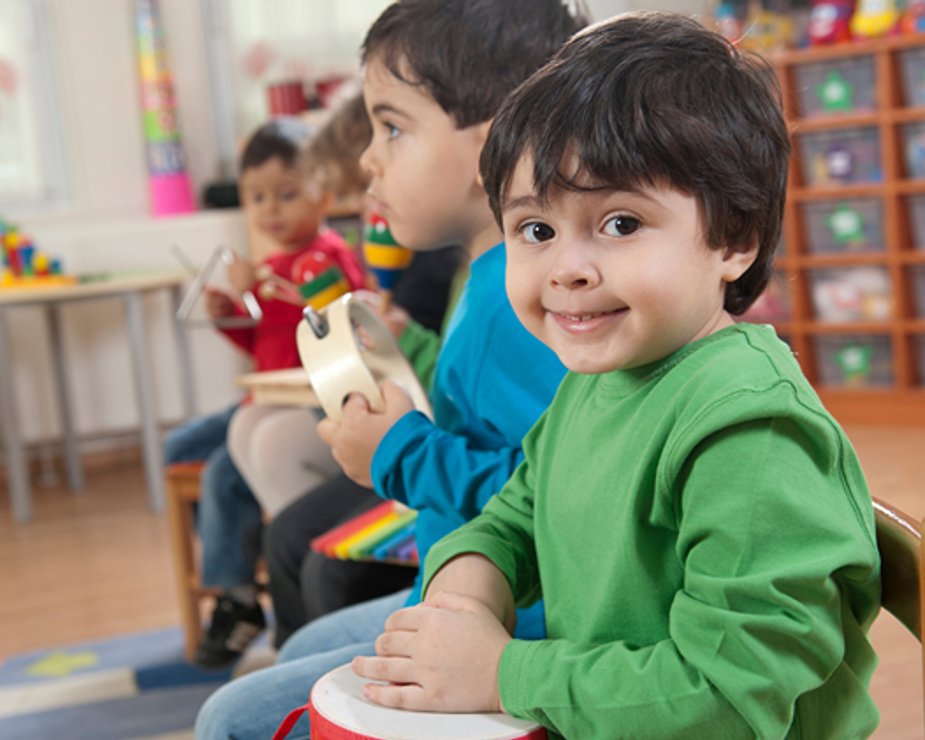 Children listening during teacher-led classroom activity.