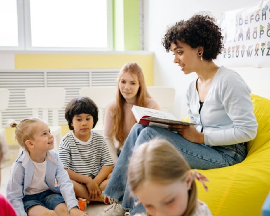 Educator leading story time with children in a daycare classroom.